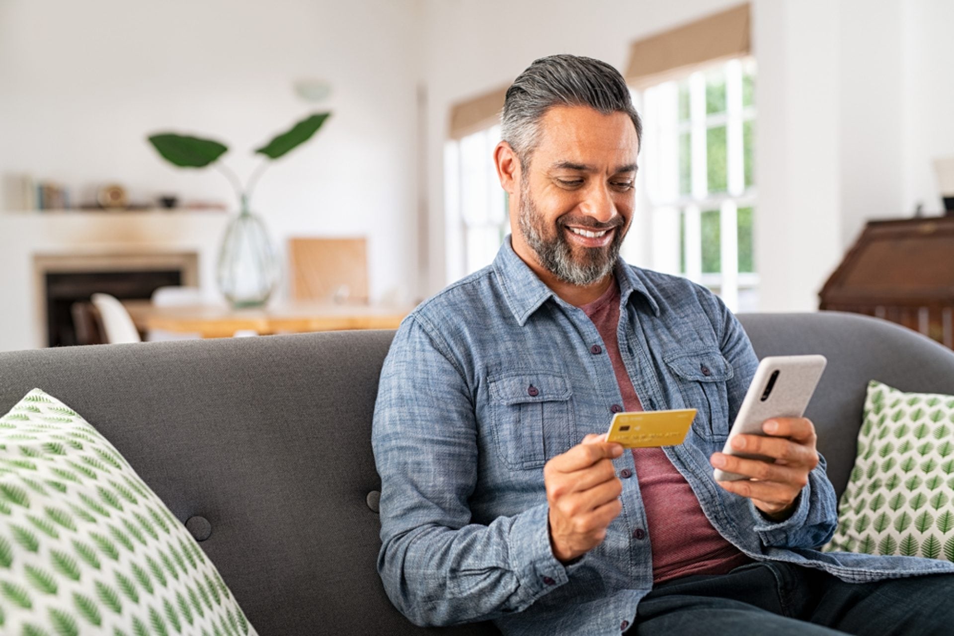 Middle,Eastern,Mature,Man,Using,Credit,Card,To,Make,Online