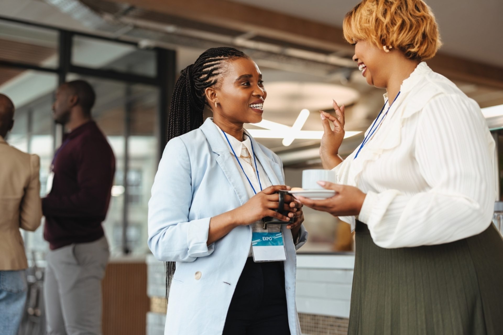 Two,Professional,African,Businesswomen,Are,Engaged,In,A,Conversation,At